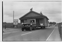 House on road, being transported by truck 